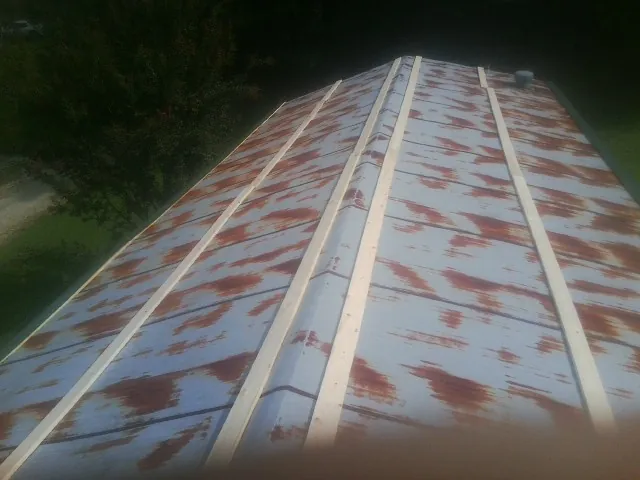 Rusted metal roof panels with new wood purlins before replacement — Storm Damage Roof Repair in West Hurley by Roofing Brothers