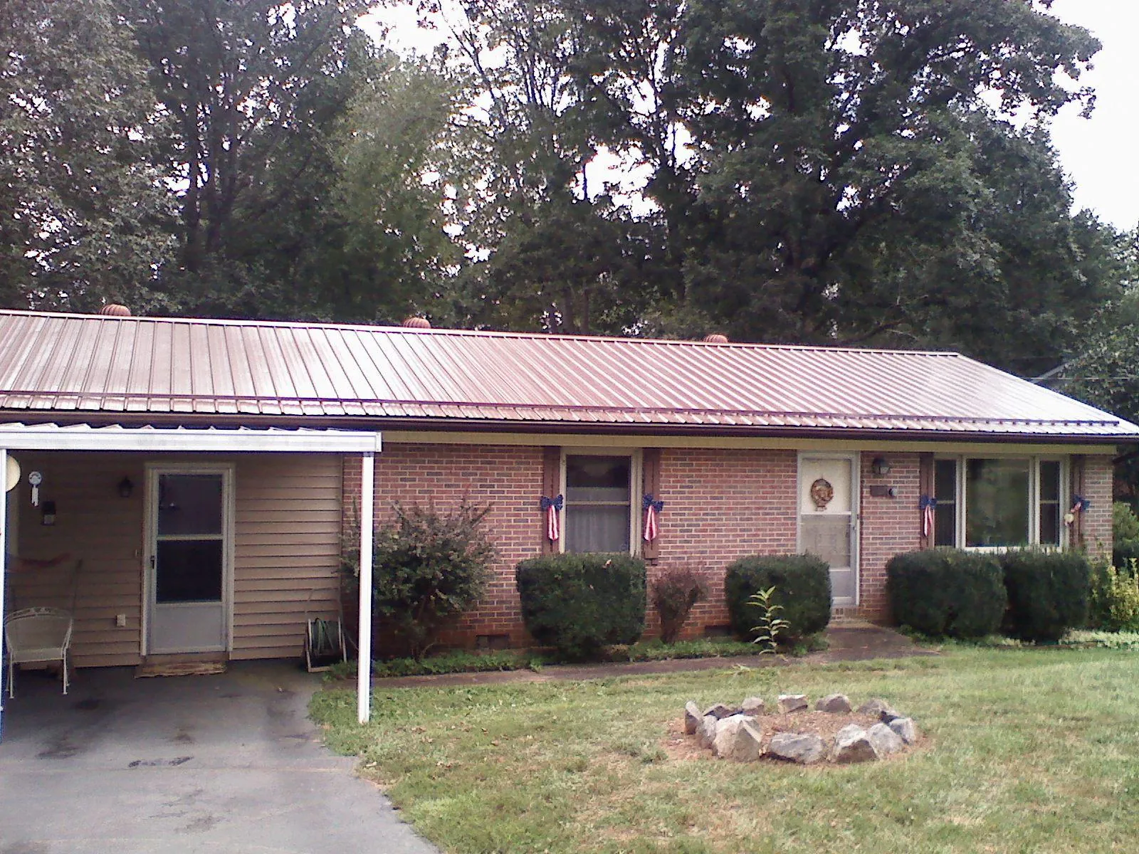 Bronze metal roof and carport on a brick ranch home — Roof Repair work by our crew in West Hurley