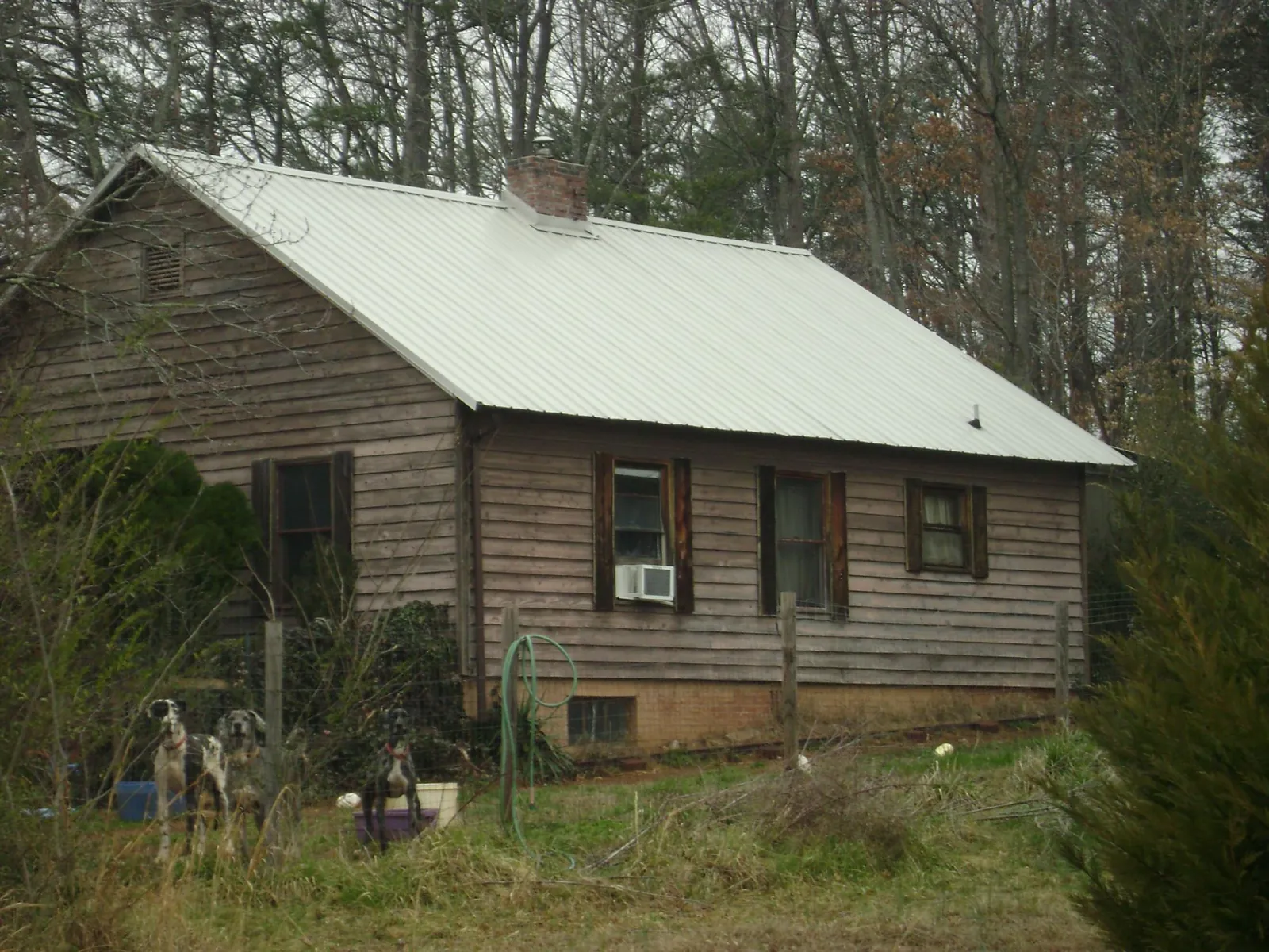 White metal roof on an old wood sided farmhouse, from a Metal Roof Installation job in West Hurley
